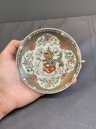 A fine Chinese famille rose armorial cup and two saucers, Yongzheng/Qianlong