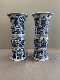 Two Chinese blue and white 'gu' vases with landscape and floral panels, Kangxi
