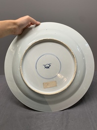 A Chinese blue, white and copper-red powder blue-ground 'peony' dish, Kangxi
