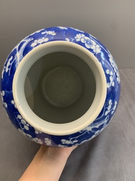 Two Chinese blue and white 'prunus on cracked ice' vases and covers, Kangxi mark, 19th C.