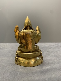 A Sino-Tibetan gilt bronze figure of a lama, 18/19th C.