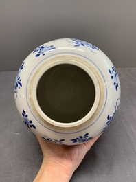 A Chinese blue and white jar with floral design and a wooden cover, Kangxi