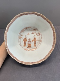 A Chinese iron-red and gilt-decorated 'ladies in a garden' bowl, Kangxi