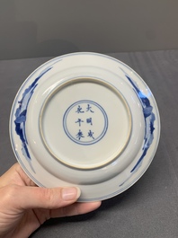 A pair of Chinese blue and white plates with a breastfeeding woman and fishermen on boats, Chenghua mark, Kangxi