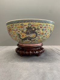 A Chinese famille rose turquoise-and-yellow-ground 'dragon' bowl on wooden stand, Qianlong mark, Republic