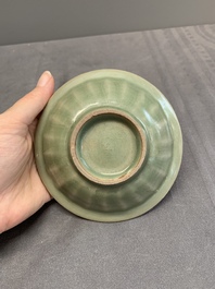 A Chinese Longquan celadon 'twin fish' dish and two 'twin fish' saucers, Yuan/Ming