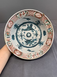 Two Chinese Swatow red-, turquoise- and black-enamelled 'phoenixes' and 'river landscape' dishes, Ming