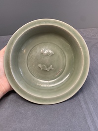 A Chinese Longquan celadon 'twin fish' dish and two 'twin fish' saucers, Yuan/Ming