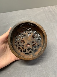 A Chinese blue and white jar with floral design and a wooden cover, Kangxi