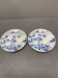 A pair of Chinese blue and white plates with a breastfeeding woman and fishermen on boats, Chenghua mark, Kangxi