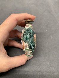 A Chinese famille rose relief-molded snuff bottle with an animated river landscape, Jiaqing mark and of the period