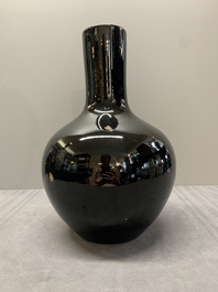 A Chinese black-glazed 'tianqiu ping' vase and a flamb&eacute;-glazed bottle vase, 19/20th C.