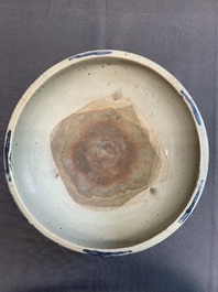 A Chinese Swatow blue and white crackle-glazed 'peonies and trigrams' tripod censer, Ming