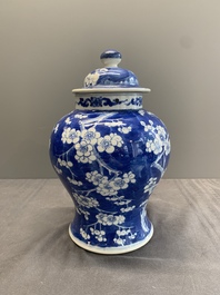 Two Chinese blue and white 'prunus on cracked ice' vases and covers, Kangxi mark, 19th C.