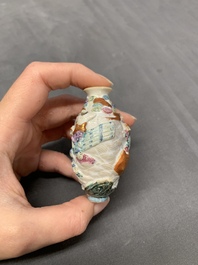 A Chinese famille rose molded 'capsized boat' snuff bottle, Qianlong mark, 19th C.