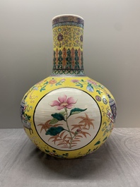 A large Chinese famille rose yellow-ground 'tianqiu ping' vase with flowers and antiquities, 19th C.