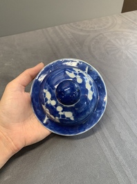 Two Chinese blue and white 'prunus on cracked ice' vases and covers, Kangxi mark, 19th C.