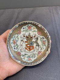 A fine Chinese famille rose armorial cup and two saucers, Yongzheng/Qianlong