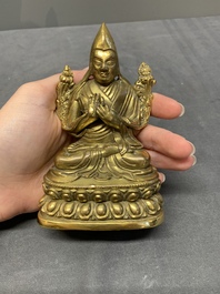 A Sino-Tibetan gilt bronze figure of a lama, 18/19th C.