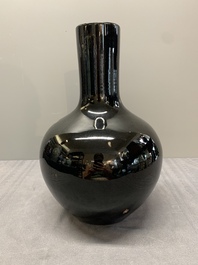 A Chinese black-glazed 'tianqiu ping' vase and a flamb&eacute;-glazed bottle vase, 19/20th C.