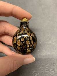 A Chinese aventurine-splashed black glass snuff bottle with a gilt stopper, 18/19th C.