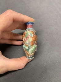 A Chinese famille rose molded 'Buddhist lions' and a grisaille 'dragon' snuff bottle, Qianlong and Daoguang mark, 19th C.