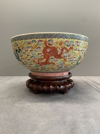 A Chinese famille rose turquoise-and-yellow-ground 'dragon' bowl on wooden stand, Qianlong mark, Republic