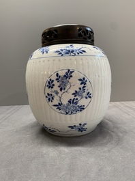 A Chinese blue and white jar with floral design and a wooden cover, Kangxi