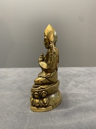 A Sino-Tibetan gilt bronze figure of a lama, 18/19th C.
