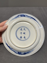 A pair of Chinese blue and white plates with a breastfeeding woman and fishermen on boats, Chenghua mark, Kangxi