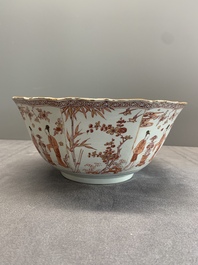 A Chinese iron-red and gilt-decorated 'ladies in a garden' bowl, Kangxi