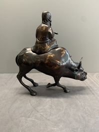 A Chinese gold-splashed bronze incense burner in the shape of an immortal riding a buffalo, 19th C.