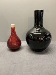 A Chinese black-glazed 'tianqiu ping' vase and a flamb&eacute;-glazed bottle vase, 19/20th C.