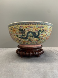A Chinese famille rose turquoise-and-yellow-ground 'dragon' bowl on wooden stand, Qianlong mark, Republic