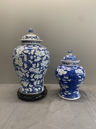 Two Chinese blue and white 'prunus on cracked ice' vases and covers, Kangxi mark, 19th C.