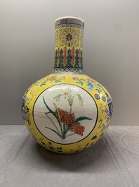 A large Chinese famille rose yellow-ground 'tianqiu ping' vase with flowers and antiquities, 19th C.