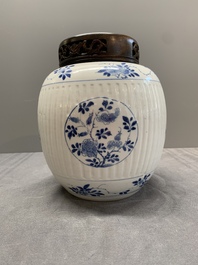A Chinese blue and white jar with floral design and a wooden cover, Kangxi