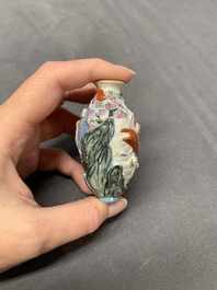 A Chinese famille rose molded 'capsized boat' snuff bottle, Qianlong mark, 19th C.