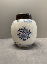A Chinese blue and white jar with floral design and a wooden cover, Kangxi