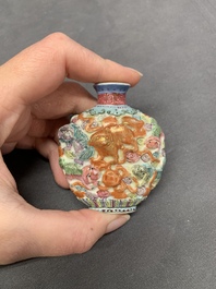 A Chinese famille rose molded 'Buddhist lions' and a grisaille 'dragon' snuff bottle, Qianlong and Daoguang mark, 19th C.