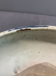 A Chinese Swatow blue and white crackle-glazed 'peonies and trigrams' tripod censer, Ming