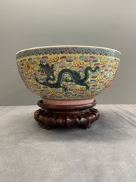 A Chinese famille rose turquoise-and-yellow-ground 'dragon' bowl on wooden stand, Qianlong mark, Republic