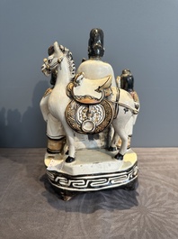A rare Chinese Cizhou group with a dignitary, two attendants and a horse, Ming