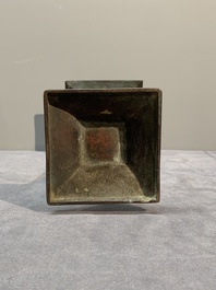 A Chinese archaistic bronze 'gu' vase and a 'hu' vase with rams in relief on a wooden stand, 18/19th C.