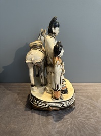 A rare Chinese Cizhou group with a dignitary, two attendants and a horse, Ming
