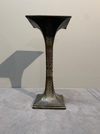 A Chinese archaistic bronze 'gu' vase and a 'hu' vase with rams in relief on a wooden stand, 18/19th C.