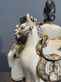 A rare Chinese Cizhou group with a dignitary, two attendants and a horse, Ming