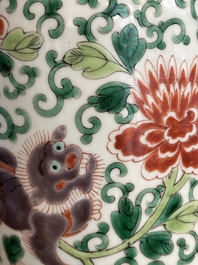 A Chinese wucai 'gu' vase with Buddhist lions, peony scrolls and figures, 19th C.