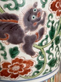 A Chinese wucai 'gu' vase with Buddhist lions, peony scrolls and figures, 19th C.