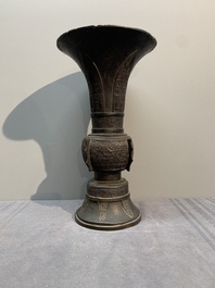 A Chinese archaistic bronze 'gu' vase with relief design, Ming